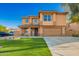 Two-story home showcasing an attractive facade, manicured lawn, and a welcoming covered porch at 3473 E Wyatt Way, Gilbert, AZ 85297