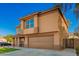 Two-story home showcasing an attractive facade, manicured lawn, and a welcoming covered porch at 3473 E Wyatt Way, Gilbert, AZ 85297