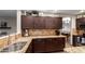 Kitchen features granite countertops and dark wood cabinets, creating a warm and inviting space for cooking and entertaining at 3473 E Wyatt Way, Gilbert, AZ 85297