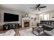 Inviting living room featuring a fireplace, large TV, and comfortable leather seating, ideal for Gathering gatherings at 3473 E Wyatt Way, Gilbert, AZ 85297