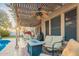 Covered patio with outdoor seating, fire pit, ceiling fan, and view of the pool at 3473 E Wyatt Way, Gilbert, AZ 85297