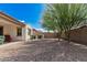 Backyard featuring mature landscaping, gravel groundcover, and block wall at 3943 E Ficus Way, Gilbert, AZ 85298
