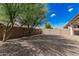 Backyard featuring mature landscaping, gravel groundcover, and block wall at 3943 E Ficus Way, Gilbert, AZ 85298