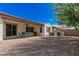 View of backyard featuring covered patio, mature landscaping, and gravel groundcover at 3943 E Ficus Way, Gilbert, AZ 85298
