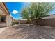 Backyard featuring mature landscaping, gravel groundcover, and block wall at 3943 E Ficus Way, Gilbert, AZ 85298