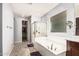 Well-lit bathroom with separate shower, soaking tub and walk-in closet at 3943 E Ficus Way, Gilbert, AZ 85298
