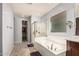 Bright bathroom features a soaking tub, shower, and walk-in closet at 3943 E Ficus Way, Gilbert, AZ 85298