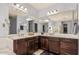 Spacious bathroom features double sinks, dark wood cabinets and a large mirror at 3943 E Ficus Way, Gilbert, AZ 85298