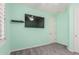 This bedroom features a ceiling fan, a wall-mounted television, and neutral-colored walls at 3943 E Ficus Way, Gilbert, AZ 85298
