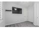 Neutrally painted bedroom with ceiling fan, carpet, and a wall-mounted television at 3943 E Ficus Way, Gilbert, AZ 85298