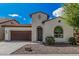 Beautiful single-story home showcasing an ornate entry door, desert landscaping, and a two-car garage at 3943 E Ficus Way, Gilbert, AZ 85298