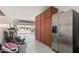 Spacious garage with ample storage cabinets and a stainless steel refrigerator at 3943 E Ficus Way, Gilbert, AZ 85298