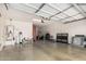 Spacious garage showcasing ample storage space, epoxy flooring and modern lighting at 3943 E Ficus Way, Gilbert, AZ 85298