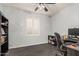 Home office with tile floors, a window with shutters, and a ceiling fan at 3943 E Ficus Way, Gilbert, AZ 85298