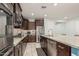 Well-equipped kitchen with stainless steel appliances, granite countertops, and a large island with a sink at 3943 E Ficus Way, Gilbert, AZ 85298