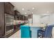 Gourmet kitchen featuring stainless steel appliances, granite countertops, a tile backsplash, and a large island at 3943 E Ficus Way, Gilbert, AZ 85298