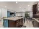 Modern kitchen features granite counters, stainless steel appliances, and an eat-in island with seating at 3943 E Ficus Way, Gilbert, AZ 85298