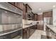 Gourmet kitchen with stainless steel appliances, granite countertops, tile backsplash, and ample cabinet space at 3943 E Ficus Way, Gilbert, AZ 85298