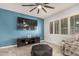 Stylish living room boasting a large TV and a blue accent wall at 3943 E Ficus Way, Gilbert, AZ 85298