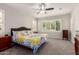 Bright main bedroom with ceiling fan, dual shuttered windows, carpet, and comfortable bed at 3943 E Ficus Way, Gilbert, AZ 85298