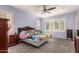 Bright main bedroom with a ceiling fan, plantation shutters, and comfortable furnishings at 3943 E Ficus Way, Gilbert, AZ 85298