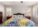 Comfortable main bedroom with large floral pattern bedspread and dual shuttered windows at 3943 E Ficus Way, Gilbert, AZ 85298