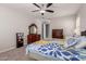 Bright main bedroom with ceiling fan, carpet, view of the ensuite, and dark wood furniture at 3943 E Ficus Way, Gilbert, AZ 85298