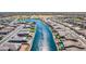 An aerial view displaying canal-front properties with landscaped backyards and waterfront access at 40835 W Agave Rd, Maricopa, AZ 85138