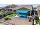 Top view of blue sunshade, pavers and turf in the backyard with lake view at 40835 W Agave Rd, Maricopa, AZ 85138