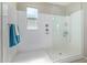 Walk in shower with glass doors and shower head at 40835 W Agave Rd, Maricopa, AZ 85138