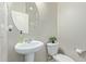 Bathroom with a pedestal sink, a round mirror, toilet, and neutral wall color at 40835 W Agave Rd, Maricopa, AZ 85138