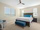 Bedroom featuring a ceiling fan, a queen bed, and an ottoman at 40835 W Agave Rd, Maricopa, AZ 85138