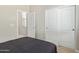 Neat bedroom showing bed and closet doors at 40835 W Agave Rd, Maricopa, AZ 85138