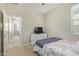 Bright bedroom featuring plush carpeting, a comfortable bed, and a classic dresser, creating a serene and inviting space at 40835 W Agave Rd, Maricopa, AZ 85138