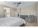 Bright bedroom featuring a ceiling fan, neutral walls, and a queen bed at 40835 W Agave Rd, Maricopa, AZ 85138