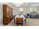 Formal dining room with a china cabinet, chandelier, and natural light at 40835 W Agave Rd, Maricopa, AZ 85138