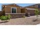 View of the front of this single story home highlighting the desert landscaping at 40835 W Agave Rd, Maricopa, AZ 85138