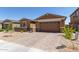 Beautiful single Gathering home featuring manicured landscaping and a brick paver driveway at 40835 W Agave Rd, Maricopa, AZ 85138