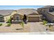 Charming single-Gathering home featuring a neatly landscaped yard, a two-car garage and brick driveway at 40835 W Agave Rd, Maricopa, AZ 85138