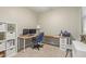 Inviting home office with a large desk and comfortable seating, providing an ideal workspace for productivity and creativity at 40835 W Agave Rd, Maricopa, AZ 85138