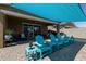 Inviting covered patio featuring comfortable Adirondack chairs, perfect for outdoor relaxation and entertaining at 40835 W Agave Rd, Maricopa, AZ 85138