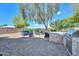 Beautiful backyard with lush landscaping, a built-in barbecue, and comfortable seating, perfect for outdoor entertaining at 4306 W Summerside Rd, Laveen, AZ 85339