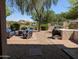 Landscaped backyard with patio seating and built-in grill, perfect for outdoor entertaining at 4306 W Summerside Rd, Laveen, AZ 85339