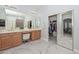 Bright bathroom featuring double sinks, marble floors, and a large, mirrored closet at 4306 W Summerside Rd, Laveen, AZ 85339