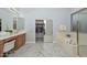 Bright bathroom with a large bathtub and marble floors adjacent to the closet at 4306 W Summerside Rd, Laveen, AZ 85339