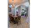 Cozy dining area featuring a wooden table, chandelier lighting, and tiled floors, creating a warm atmosphere at 4306 W Summerside Rd, Laveen, AZ 85339