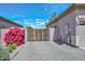 Property featuring a private, gated driveway, beautiful shrubs, and mature trees, enhancing privacy at 4306 W Summerside Rd, Laveen, AZ 85339