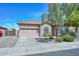 Single-story home with a 2-car garage and meticulously landscaped front yard and walkway at 4306 W Summerside Rd, Laveen, AZ 85339