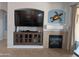 Inviting living room with a tiled fireplace, mounted television, and decorative turtle accent at 4306 W Summerside Rd, Laveen, AZ 85339