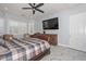 Spacious main bedroom features a ceiling fan, large TV, and plantation shutters at 4306 W Summerside Rd, Laveen, AZ 85339